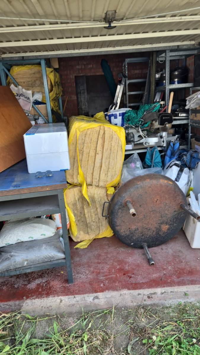 Garage vóór de ontruiming — vol met diverse materialen en spullen